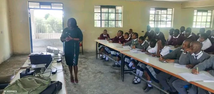 Mercy speaking to a class of boys