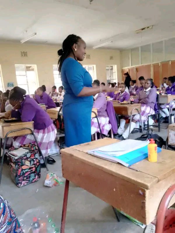 Mercy speaking to a class of girls